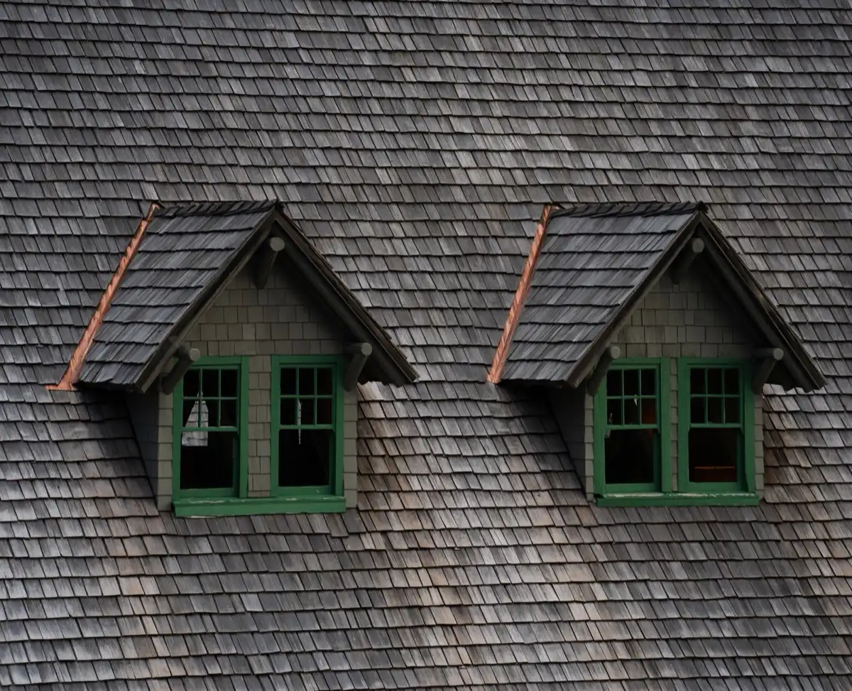 Dormers on a shingle roof in Melbourne, FL, where step flashing and kickout flashing carry water past the walls